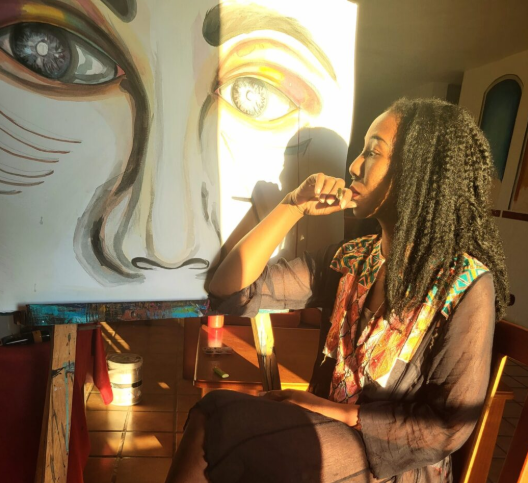 Artist Shay Chenette painting in her studio